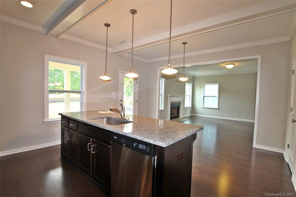 2254 Bluebell Way, Unit 156 Fort Mill, SC 29708 - Photo 7 of 23 a kitchen with a sink chandelier and wooden floor