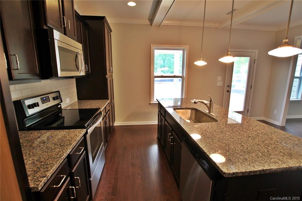 2254 Bluebell Way, Unit 156 Fort Mill, SC 29708 - Photo 8 of 23 a kitchen with stainless steel appliances granite countertop a sink a stove top oven a counter space and cabinets