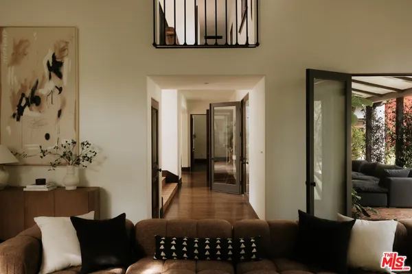a living room with furniture a fireplace and potted plants