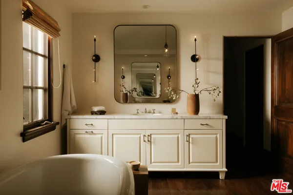 a bedroom with bed and a large window