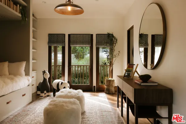 a bedroom with a bed and a book shelf