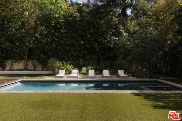 a view of swimming pool with chairs