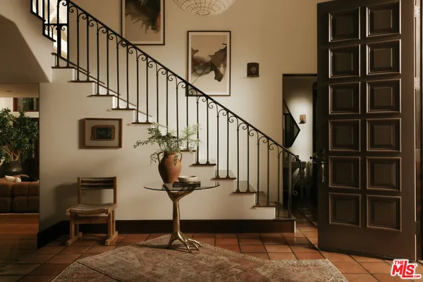 a dining room with a large window and couch