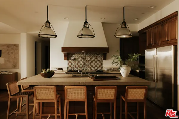 a kitchen with granite countertop a sink stainless steel appliances and cabinets