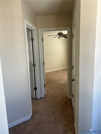 a view of a livingroom with a ceiling fan and window