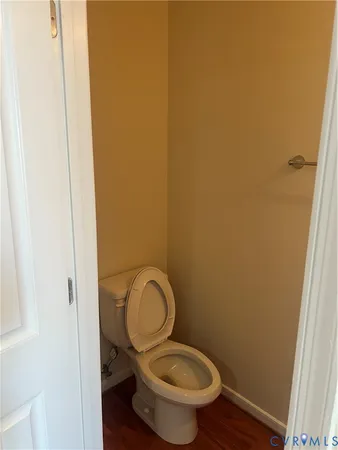 a bathroom with a granite countertop toilet and a sink