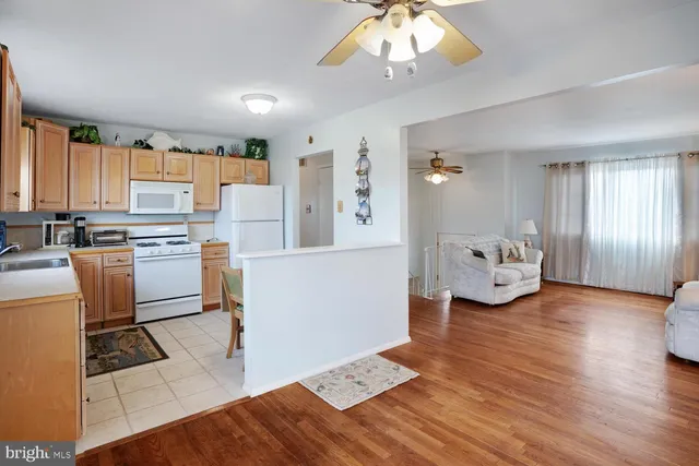 a view of a dining room with furniture and a chandelier fan