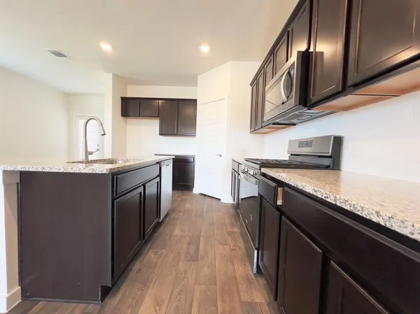 a kitchen with stainless steel appliances granite countertop counter space a sink and cabinets