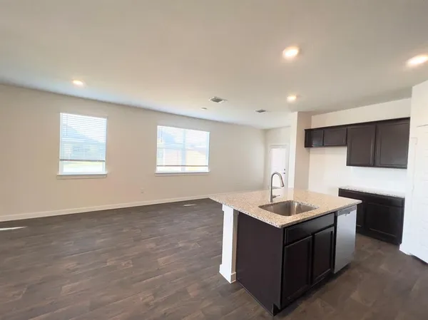 a kitchen with stainless steel appliances granite countertop a sink and a stove