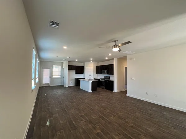 a view of a living room hardwood floor and furniture
