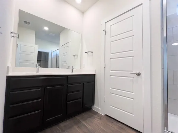 a bathroom with a double vanity sink and mirror