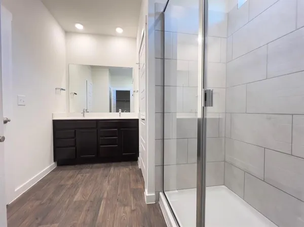 a bathroom with a vanity a bath tub and shower