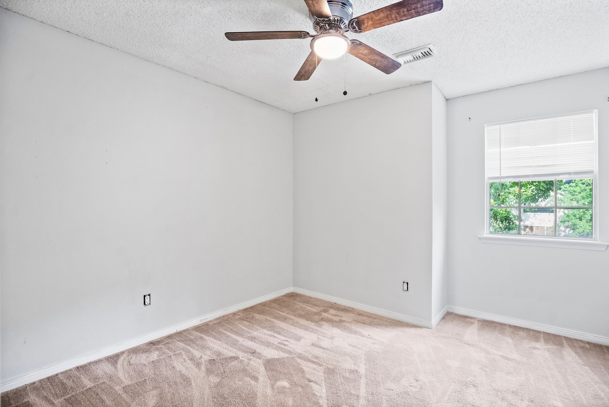 22 South Rain Forest Court Spring, TX 77380 - Photo 11 of 29 an empty room with a window and a fan