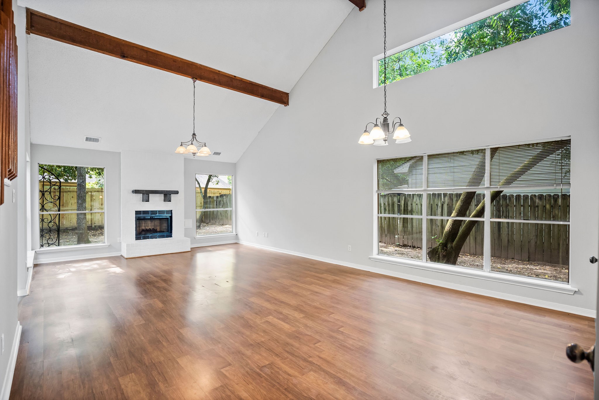 22 South Rain Forest Court Spring, TX 77380 - Photo 2 of 29 an empty room with wooden floor and a fireplace