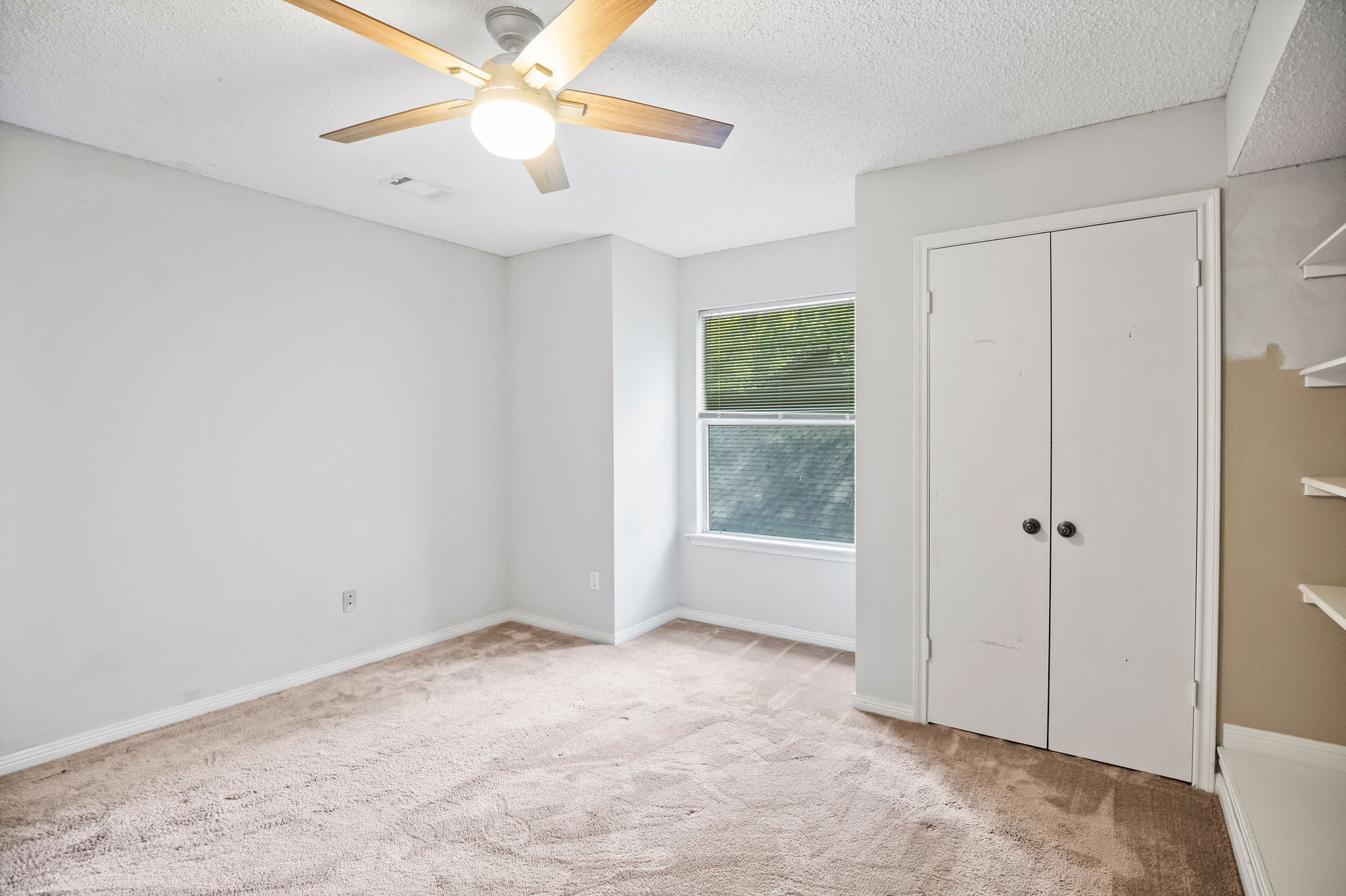 22 South Rain Forest Court Spring, TX 77380 - Photo 25 of 29 a view of an empty room and window with a ceiling fan