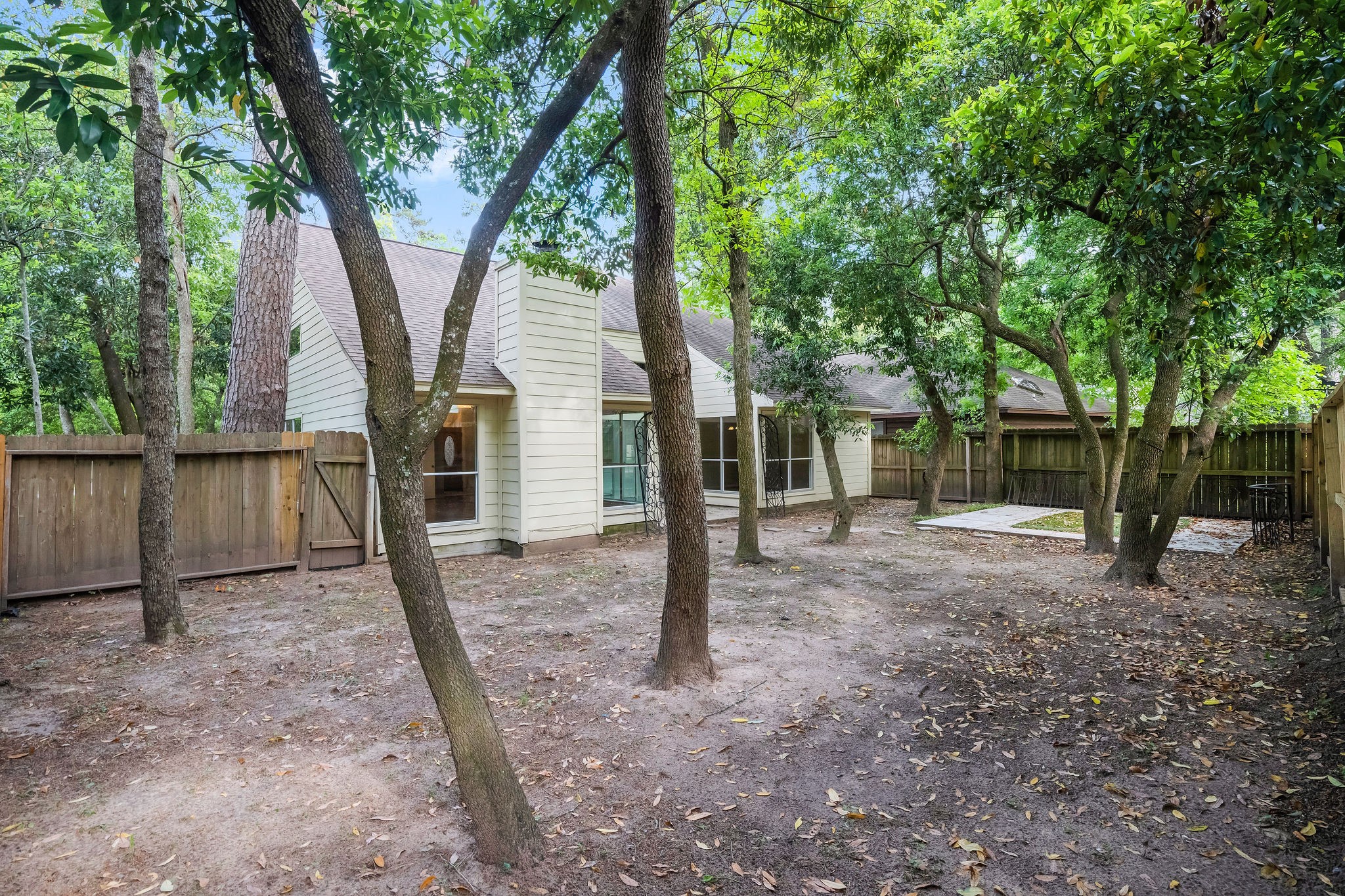 22 South Rain Forest Court Spring, TX 77380 - Photo 28 of 29 a view of a house with backyard and a tree