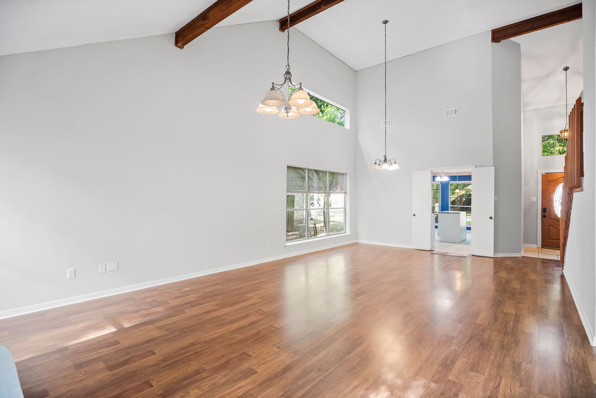 22 South Rain Forest Court Spring, TX 77380 - Photo 3 of 29 a view of an empty room with wooden floor and a window