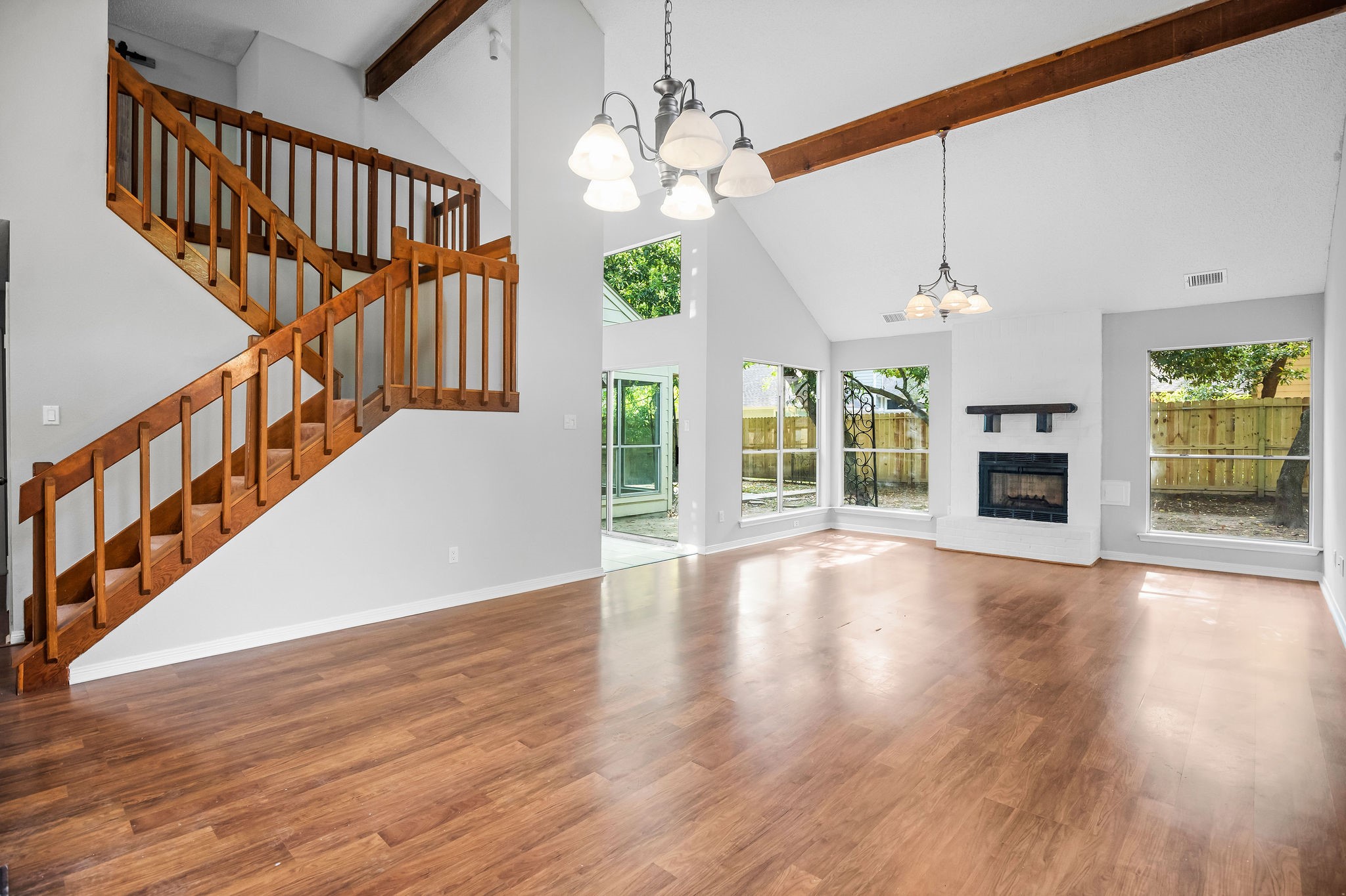 22 South Rain Forest Court Spring, TX 77380 - Photo 5 of 29 a view of an empty room with wooden floor fireplace and a window