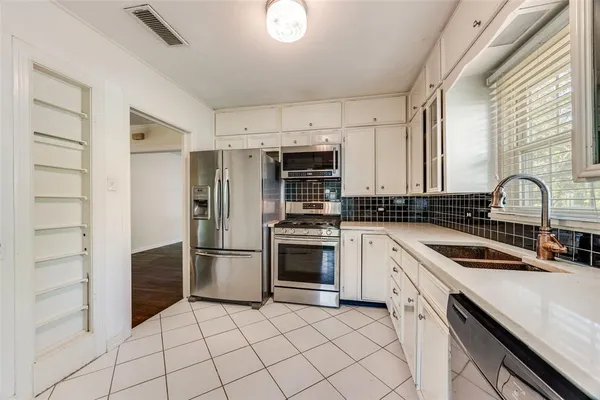 a kitchen with granite countertop a cabinets and steel stainless steel appliances