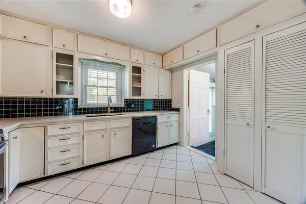 a kitchen with a refrigerator a sink and cabinets
