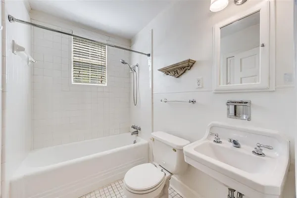 a white toilet sitting next to a bath tub