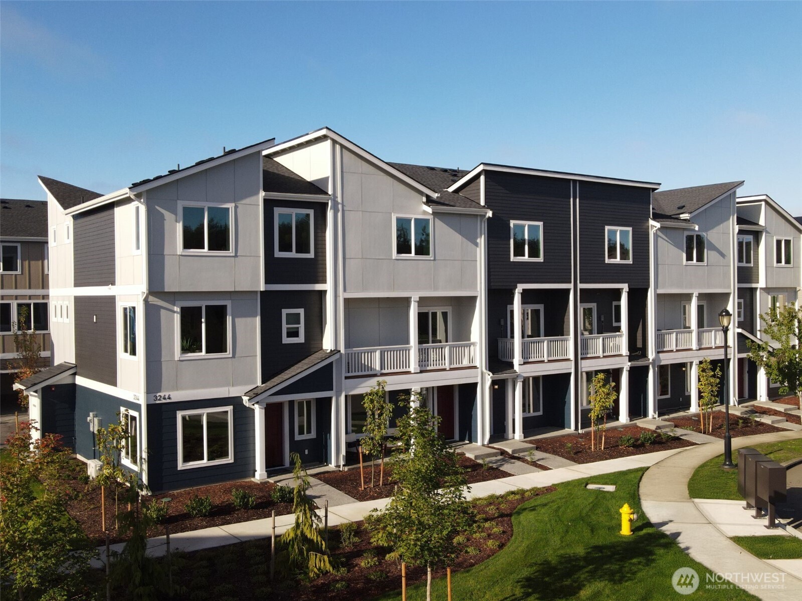 a front view of a residential apartment building with a yard