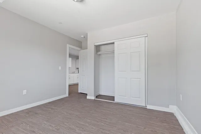 a view of an empty room with wooden floor