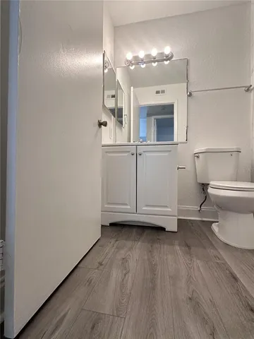 a bathroom with a toilet and a bath tub