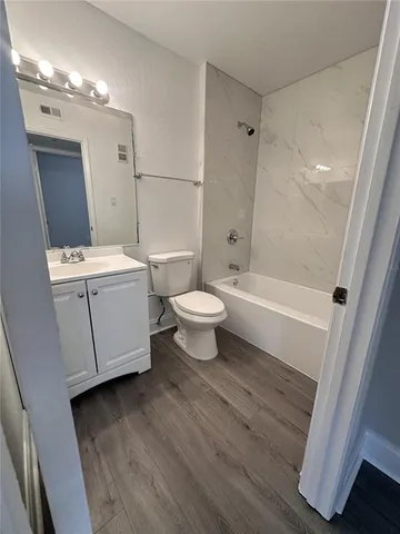 a bathroom with a bathtub and a toilet