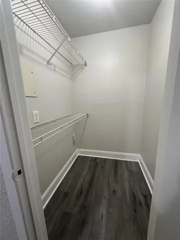 a view of a hallway with wooden floor and stairs