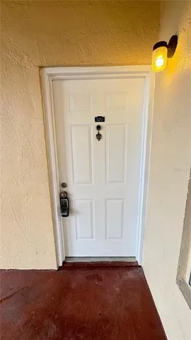 an empty room with wooden floor and mirror