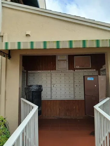 a green field with lots of trees in the background