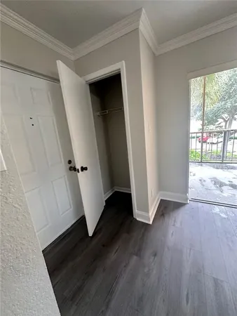 an empty room with wooden floor and a window