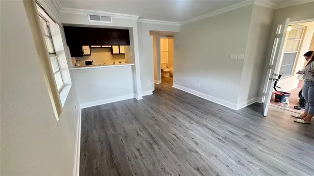 a kitchen with stainless steel appliances a stove and wooden floor