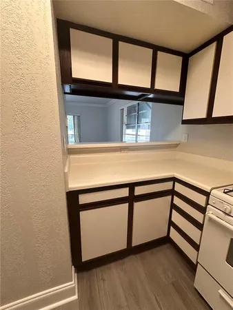 a kitchen with a stove and a white cabinet