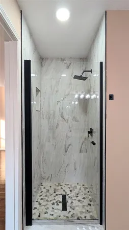 a bathroom with a granite countertop shower