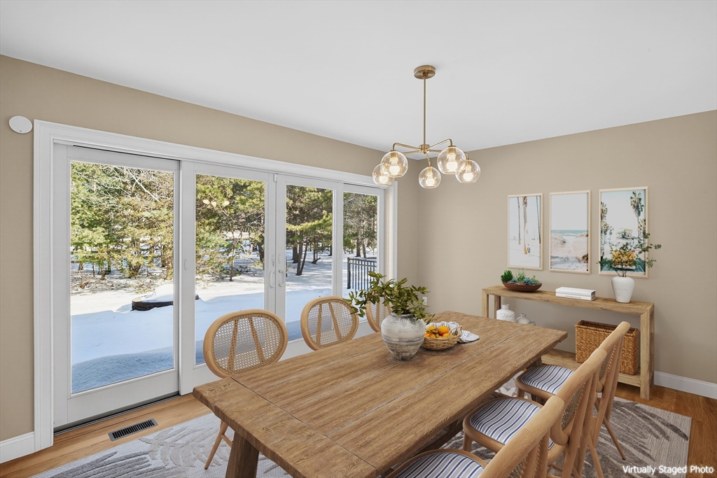 26 Crosswinds Way Falmouth, MA 02536 - Photo 22 of 41 a dining room with furniture a chandelier and wooden floor