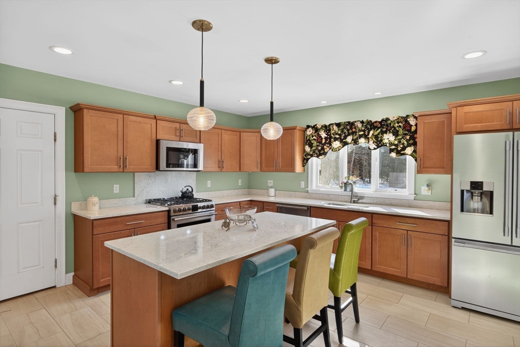 26 Crosswinds Way Falmouth, MA 02536 - Photo 24 of 41 a kitchen with stainless steel appliances granite countertop a sink a stove and a wooden floors