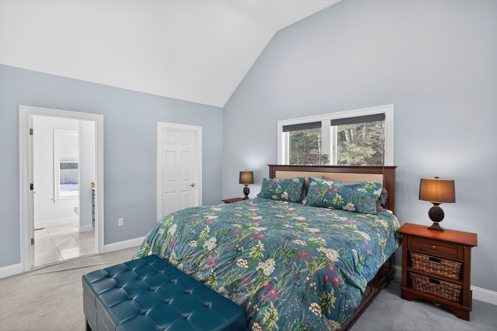 26 Crosswinds Way Falmouth, MA 02536 - Photo 30 of 41 a bedroom with a bed and wooden floor