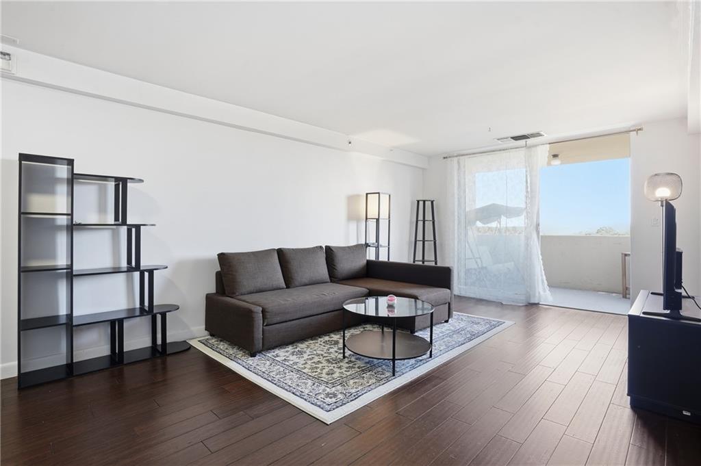1501 Clairmont Road, Unit 1316 Decatur, GA 30033 - Photo 15 of 25 a living room with furniture and a wooden floor