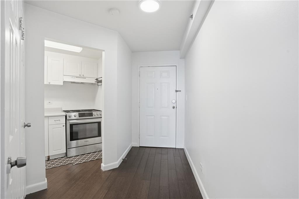 1501 Clairmont Road, Unit 1316 Decatur, GA 30033 - Photo 4 of 25 a view of a kitchen with a stove wooden floor and staircase