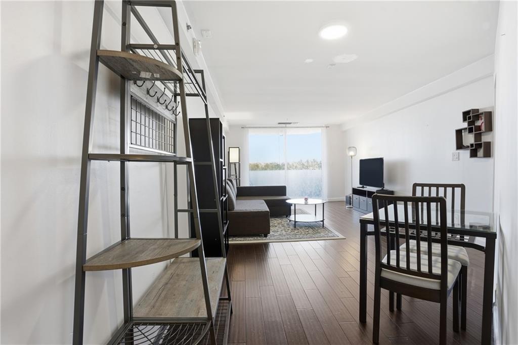 1501 Clairmont Road, Unit 1316 Decatur, GA 30033 - Photo 5 of 25 a living room with furniture a wooden floor and a window