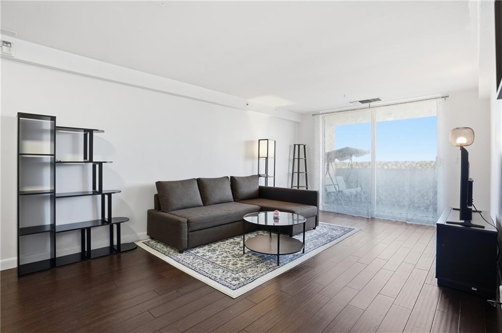 1501 Clairmont Road, Unit 1316 Decatur, GA 30033 - Photo 8 of 25 a living room with furniture and wooden floor