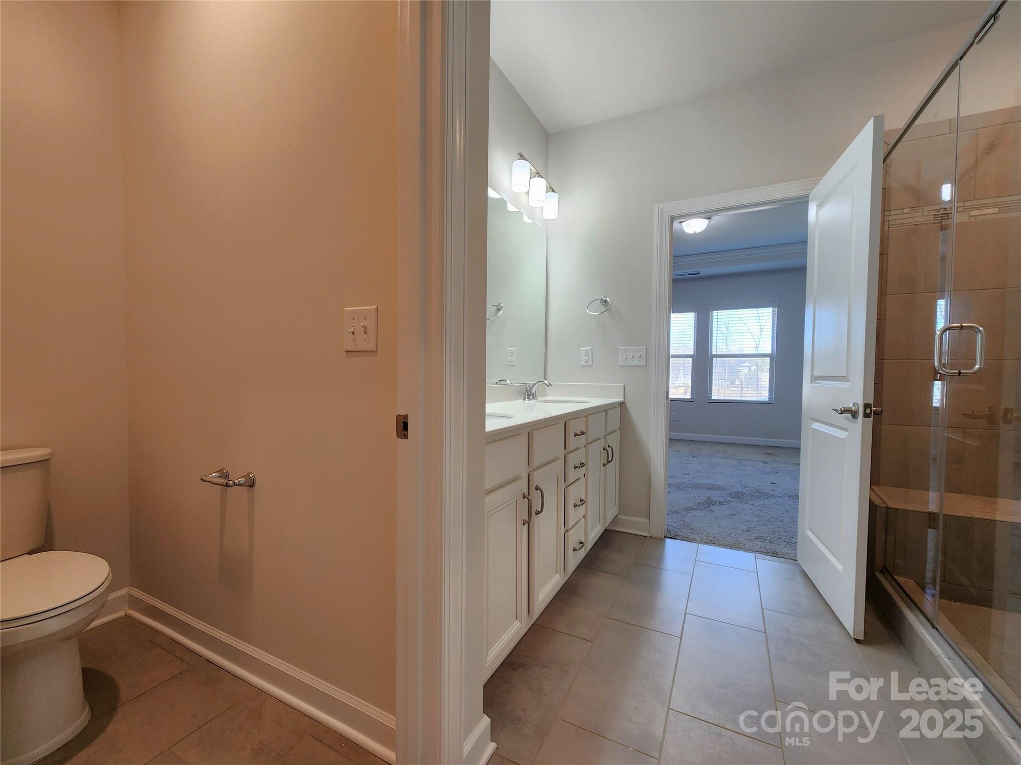 4227 Canopy Creek Drive Denver, NC 28037 - Photo 22 of 33 a bathroom with a granite countertop sink a toilet and shower