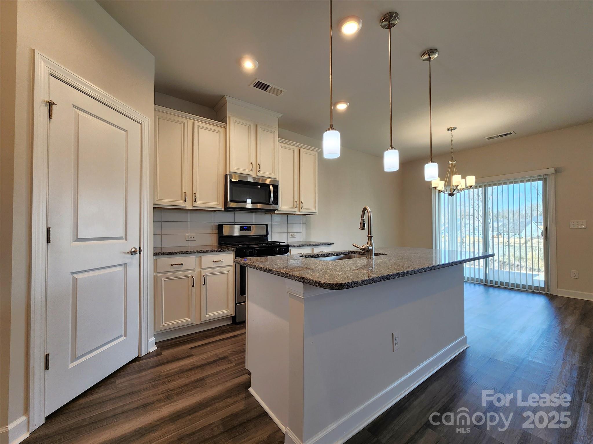 4227 Canopy Creek Drive Denver, NC 28037 - Photo 4 of 33 a kitchen with stainless steel appliances granite countertop a sink a stove and a refrigerator