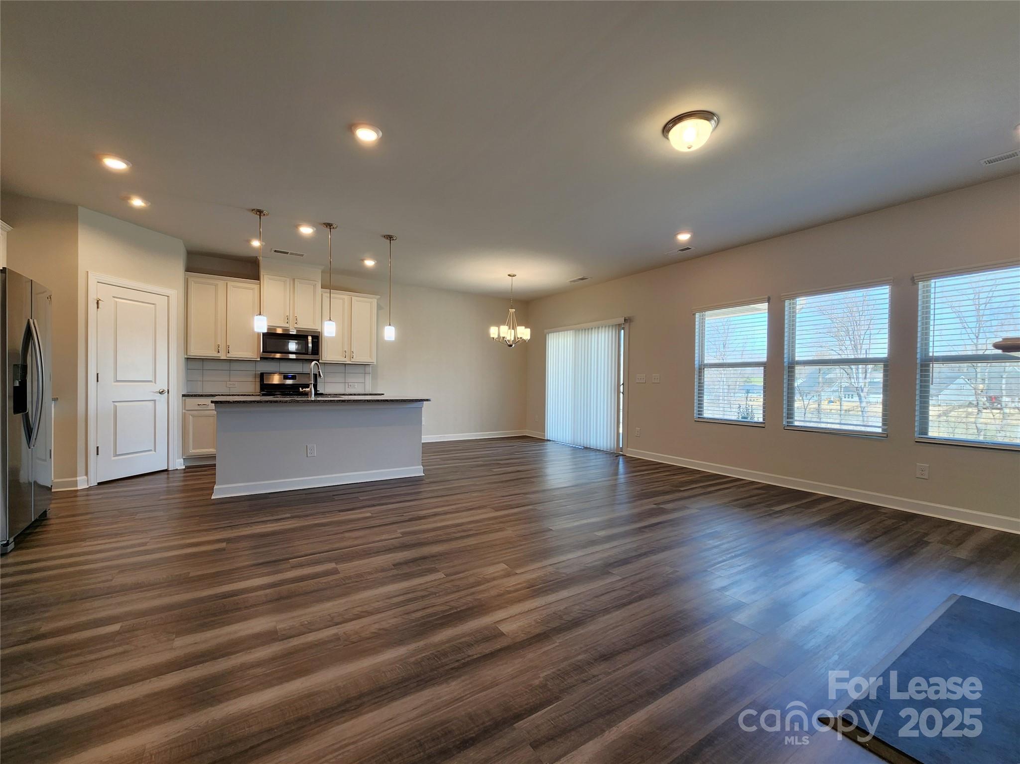 4227 Canopy Creek Drive Denver, NC 28037 - Photo 10 of 33 an open kitchen with kitchen island a sink dishwasher stove and wooden floor