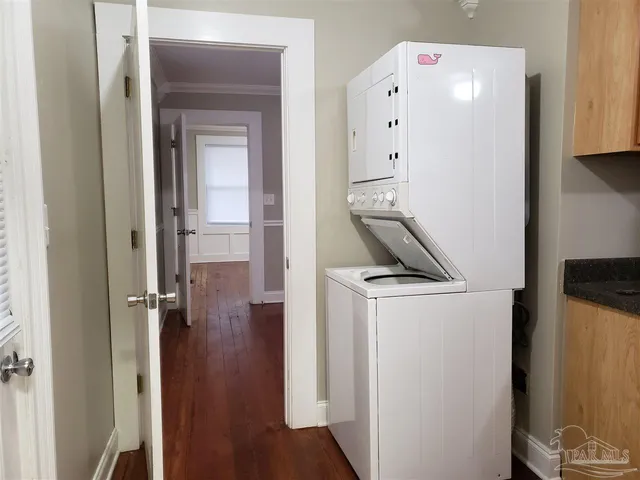 a view of bathroom with a sink mirror and window