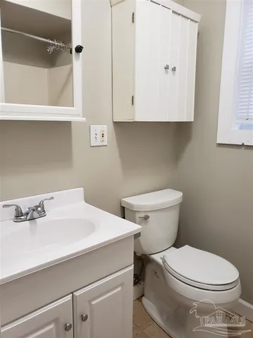 a white toilet sitting next to a bathroom sink