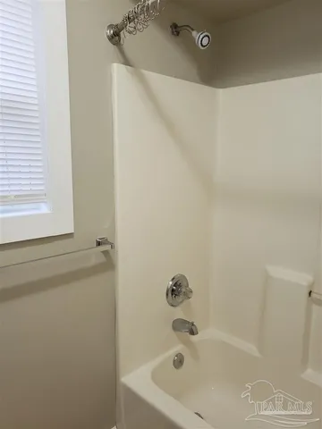 a bathroom with a tub and a shower