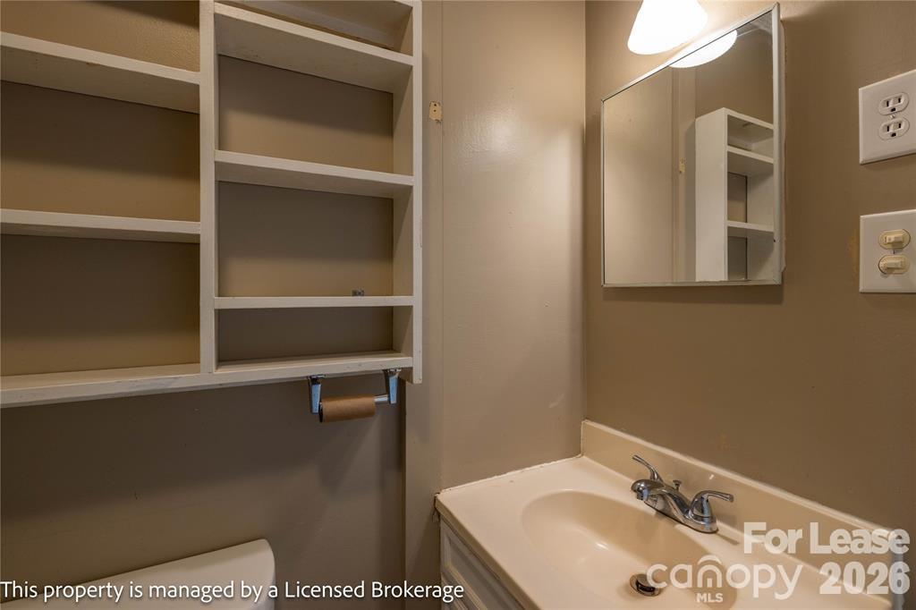 213 Roslyn Road Troy, NC 27371 - Photo 21 of 25 a bathroom with a sink and a mirror